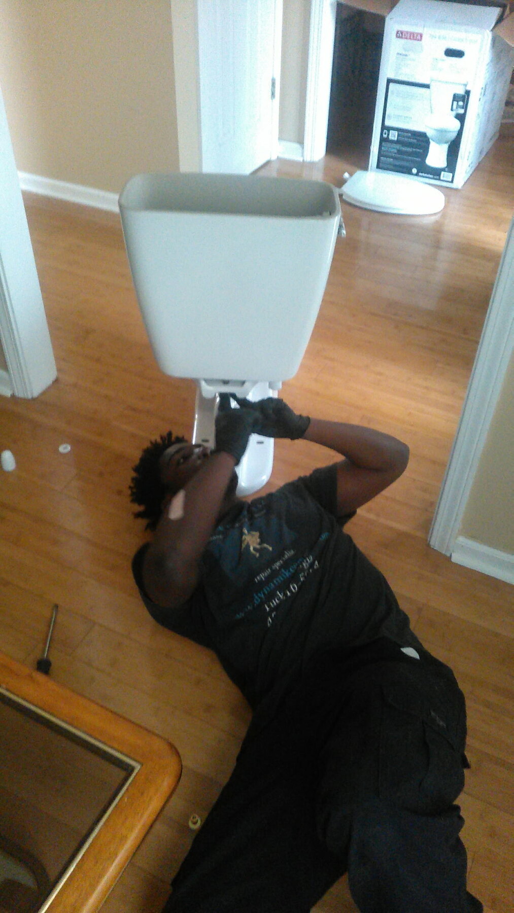 Dynamike Empire technician installing a toilet
